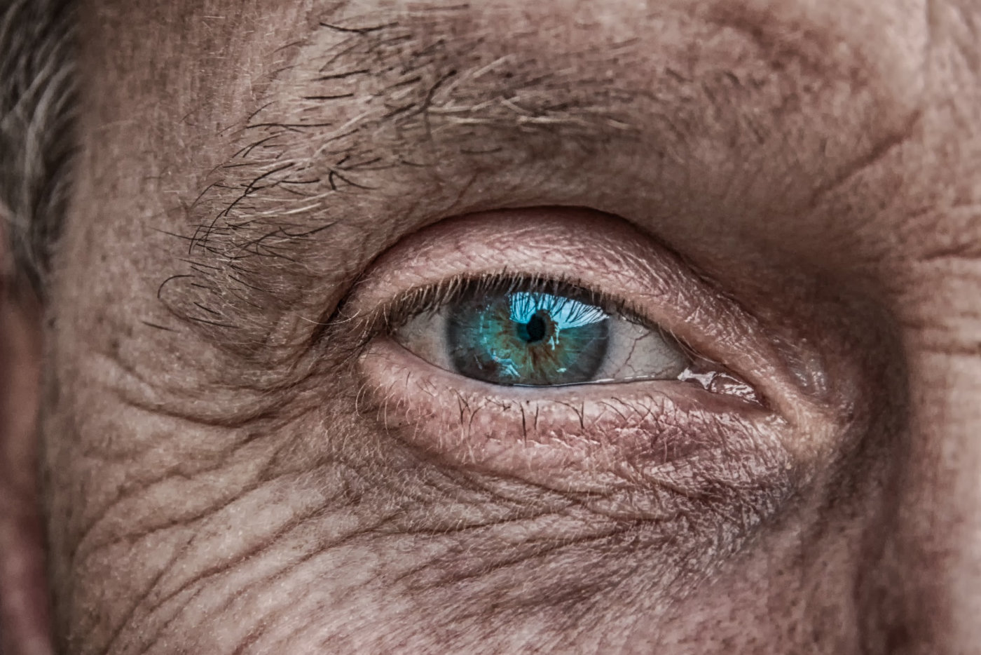 A close-up shot capturing the blue eyes of a senior man